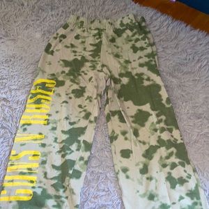 Camo green sweatpants with Guns N’ Roses printed on the right side.